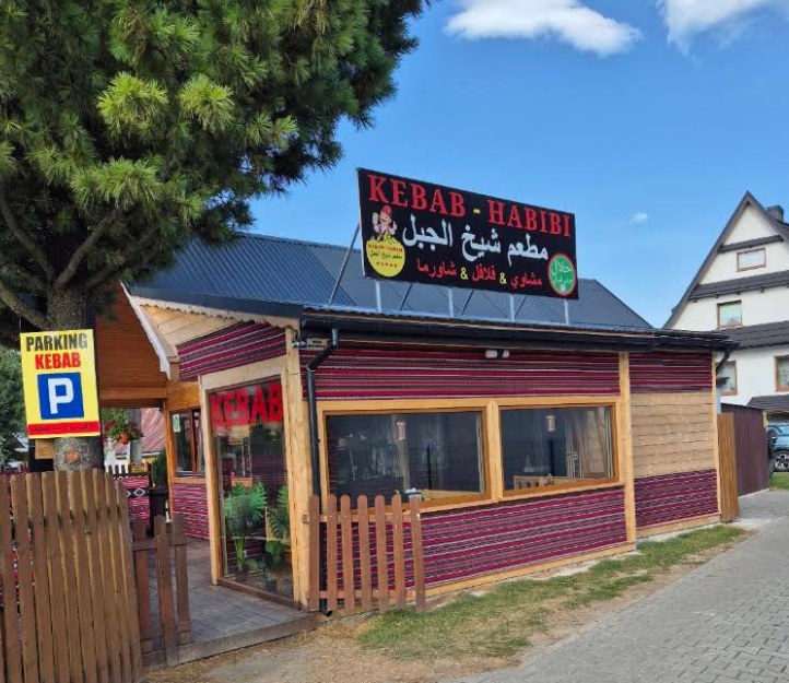 Kebab Habibi in Zab: timber and kilim-clad frontage with the KEBAB HABIBI sign